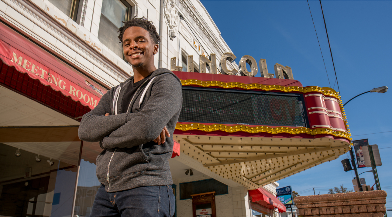 confident teen standing outside a theater