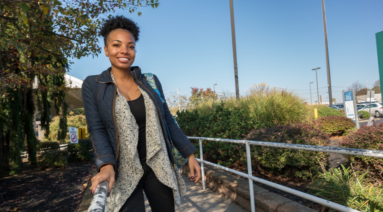 Woman standing outside, smiling