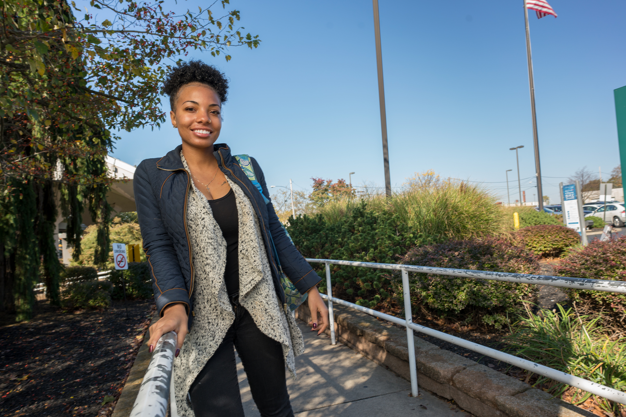 woman standing outside, smiling